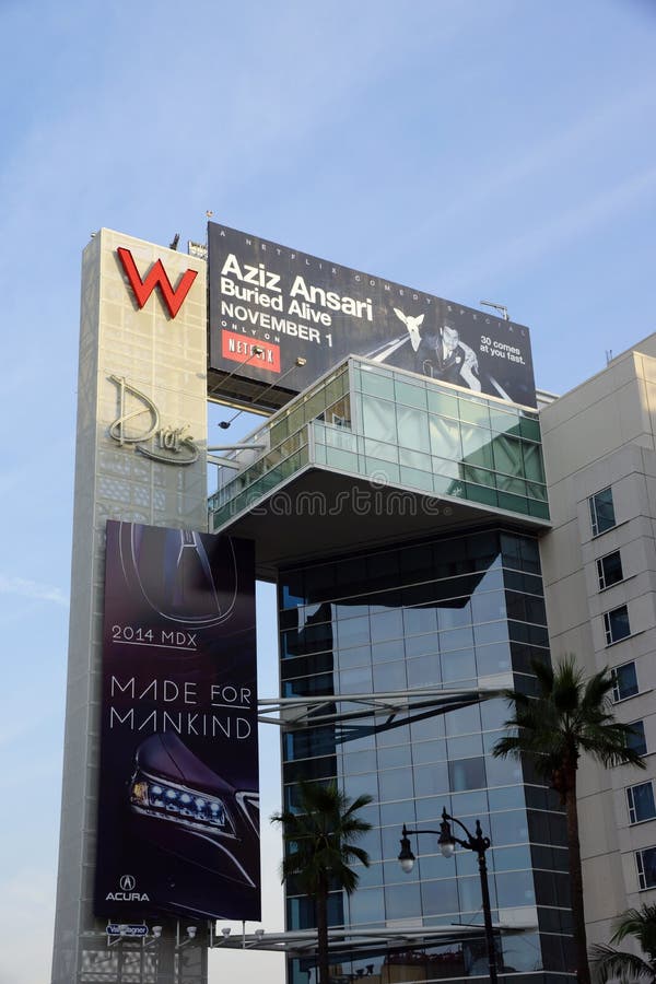 Big Red W and Drais signs with ads for Aziz Ansariand Acura on t