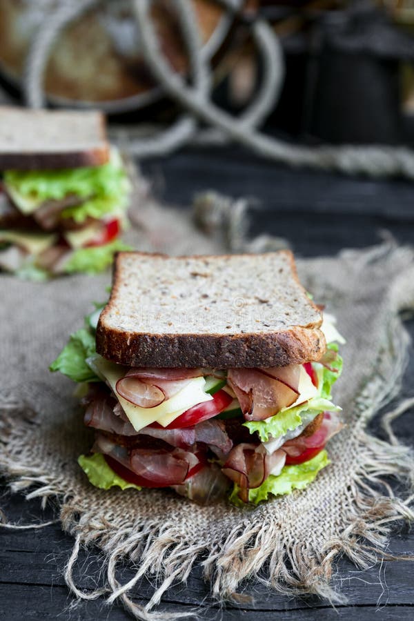 Sandwich with Bread, Prosciutto, Lettuce, Tomtatoes, Cucumber and