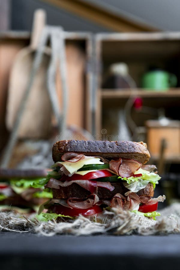 Sandwich with Bread, Prosciutto, Lettuce, Tomtatoes, Cucumber and