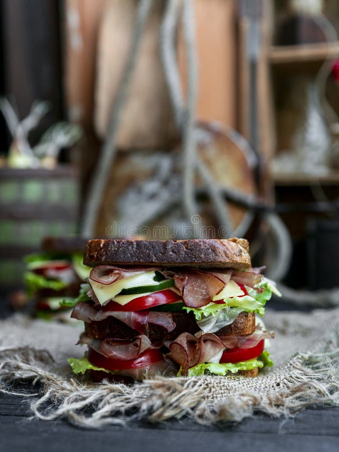 Sandwich with Bread, Prosciutto, Lettuce, Tomtatoes, Cucumber and