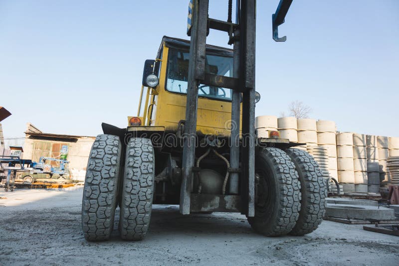 Big Spiked Wheels of Yellow Tractor Durable Rubber Tires Stock Photo