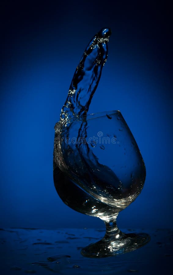 Big splash of fluid in a glass
