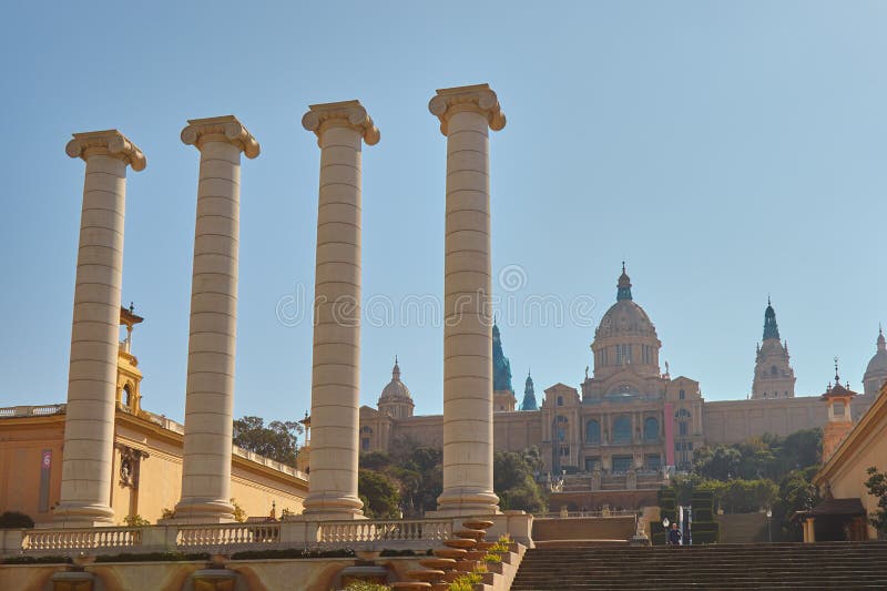 Big, strong stone columns on the street in Barcelona in Spain, hill Montjuic. In a background the National Museum of Catalonia