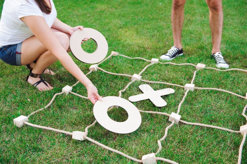 Big Tic Tac Toe Game. Guy and Girl Playing Outdoors. Stock Image