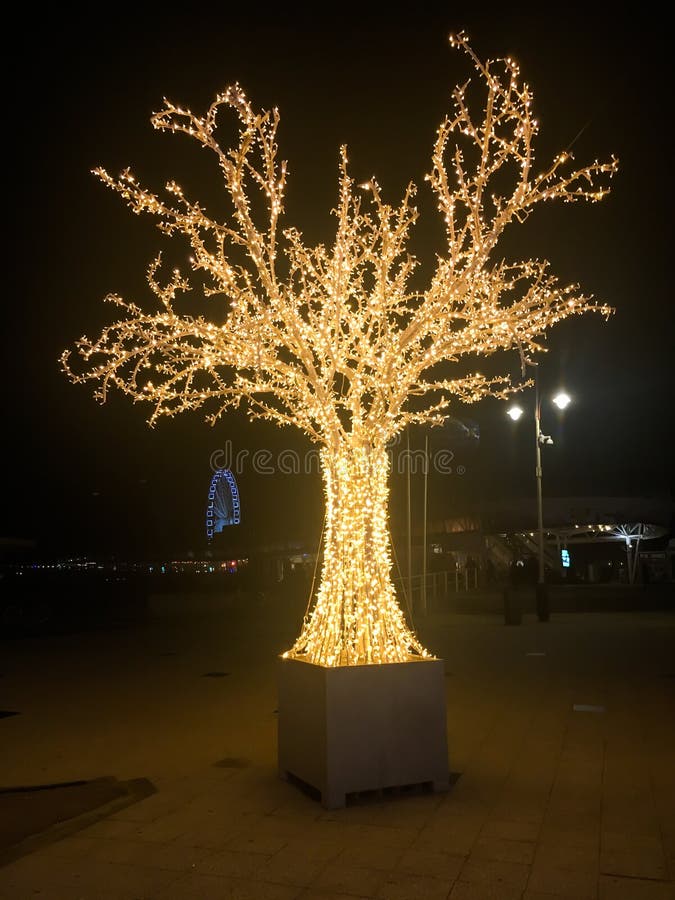 Decorated Christmas Tree with Lighted Lights Isolated on a White Brick