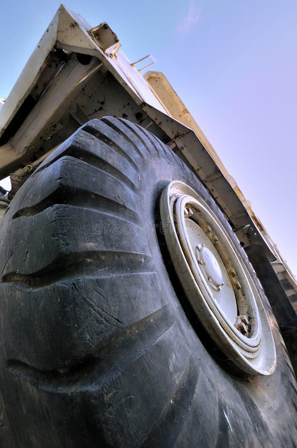 Big tyre and construction loader under sky