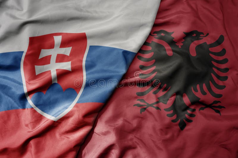 Big waving national colorful flag of slovakia and national flag of albania