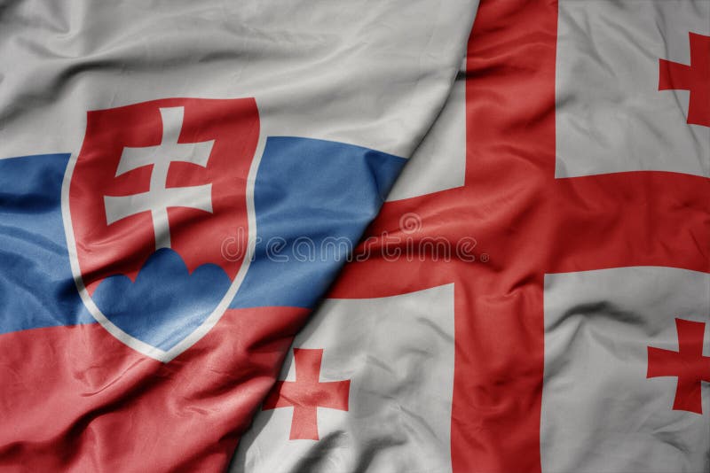 Big waving national colorful flag of slovakia and national flag of georgia