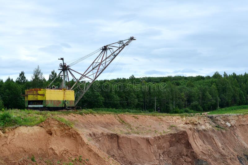 Biggest excavator dragline with a large bucket for the quarry overburden stripping. stock image