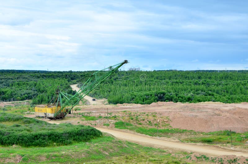Biggest excavator dragline with a large bucket for the quarry overburden stripping. Belarus, Vitebsk, largest dolomite deposit in a open pit `Gralevo`