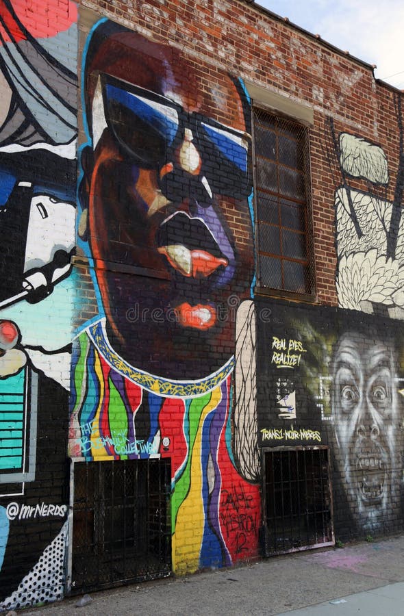 A wall graffiti of the rapper, Biggie Smalls, who was also known as Notorious B. I. G. he was killed by drive-by shooting. This graffiti is part of the Bushwick collection, a display of street art on the walls of Bushwick, Brooklyn, NY. A wall graffiti of the rapper, Biggie Smalls, who was also known as Notorious B. I. G. he was killed by drive-by shooting. This graffiti is part of the Bushwick collection, a display of street art on the walls of Bushwick, Brooklyn, NY