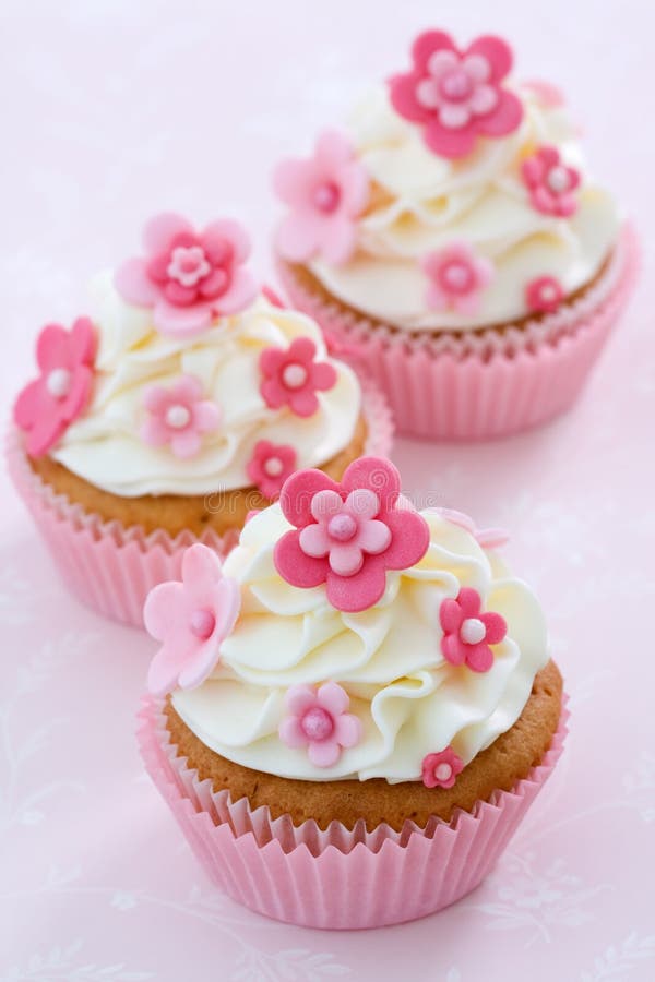 Cupcakes decorated with pink fondant flowers. Cupcakes decorated with pink fondant flowers