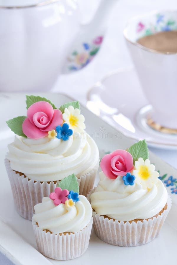 Afternoon tea served with flower cupcakes. Afternoon tea served with flower cupcakes