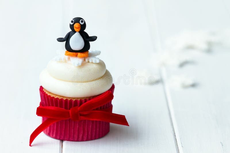 Penguin cupcake with copy space to side. Penguin cupcake with copy space to side