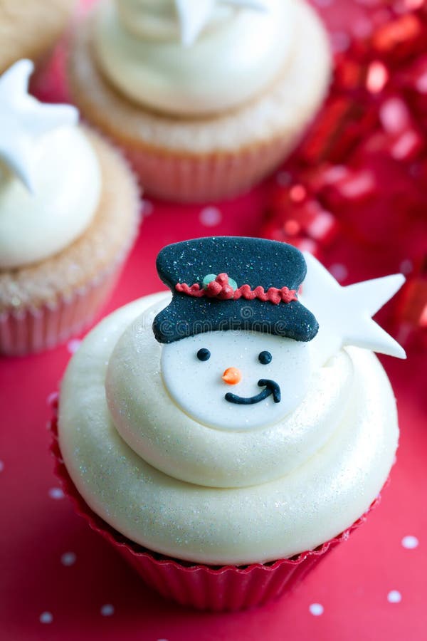 Festive cupcake decorated with a sugar snowman. Festive cupcake decorated with a sugar snowman