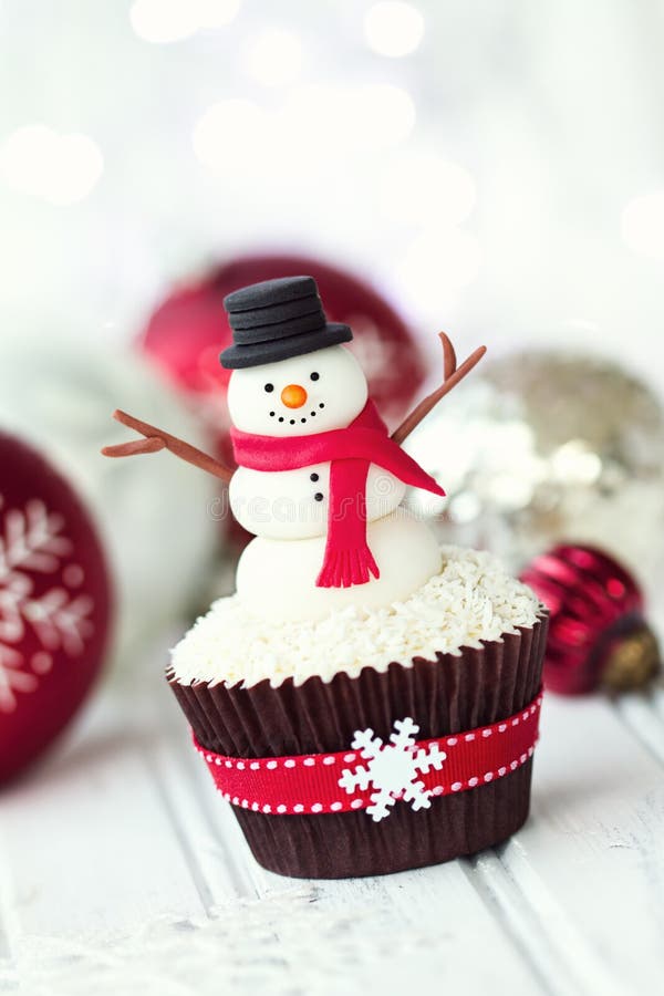 Cupcake decorated with a fondant snowman. Cupcake decorated with a fondant snowman