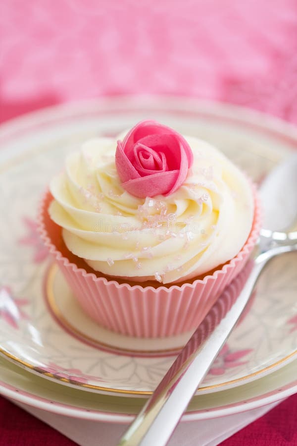 Pink rosebud cupcake, ready to eat. Pink rosebud cupcake, ready to eat