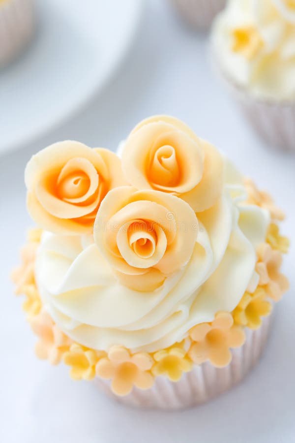 Cupcake decorated with golden sugar roses. Cupcake decorated with golden sugar roses