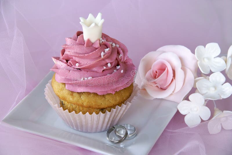 Wedding cupcake with rings and sugar flowers. Wedding cupcake with rings and sugar flowers