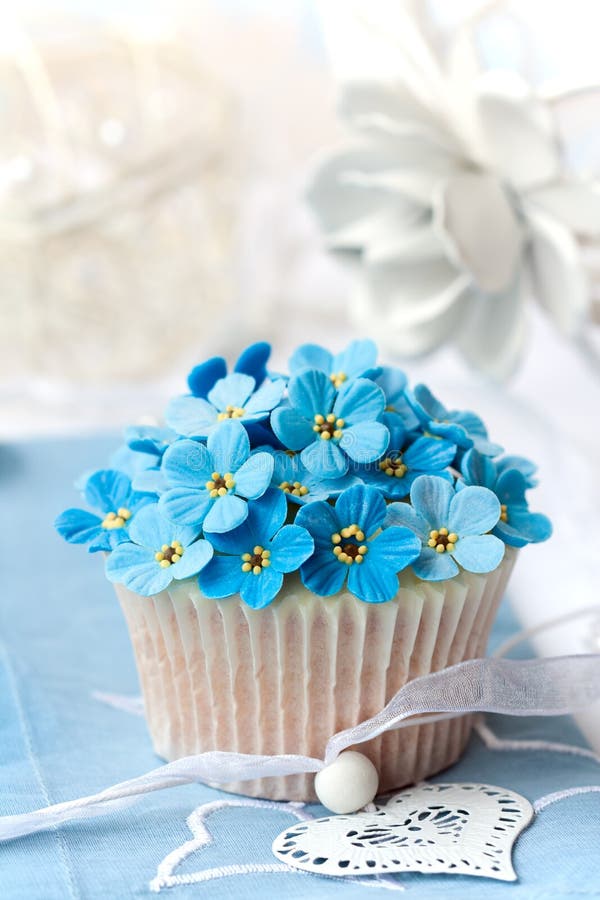 Cupcake decorated with sugar forget-me-nots. Cupcake decorated with sugar forget-me-nots