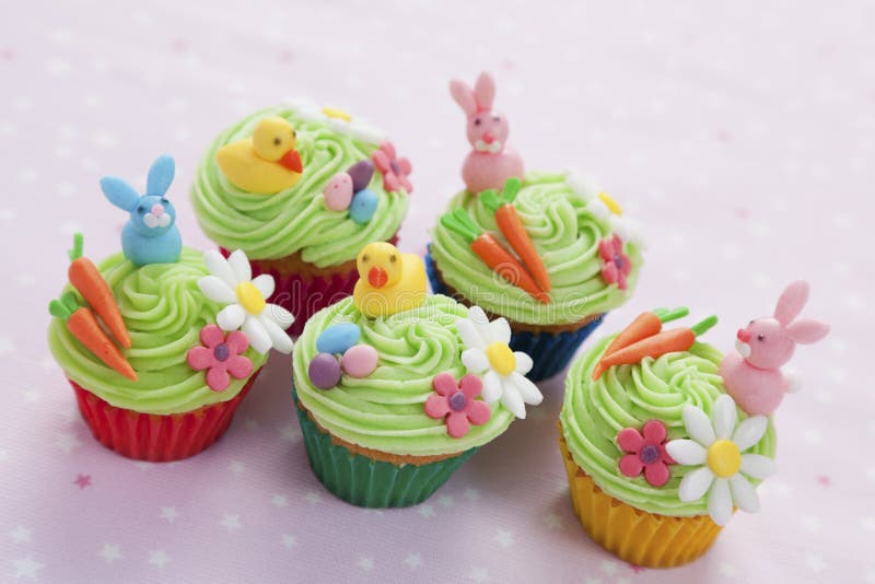 Five easter themed cupcakes with bunnies, chicks, eggs, carrots and flowers. Five easter themed cupcakes with bunnies, chicks, eggs, carrots and flowers