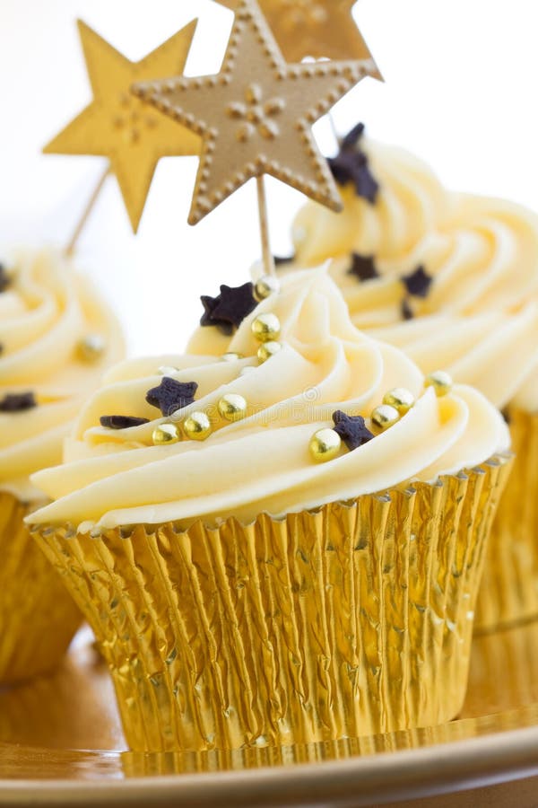 Cupcakes decorated with chocolate stars and golden dragees. Cupcakes decorated with chocolate stars and golden dragees