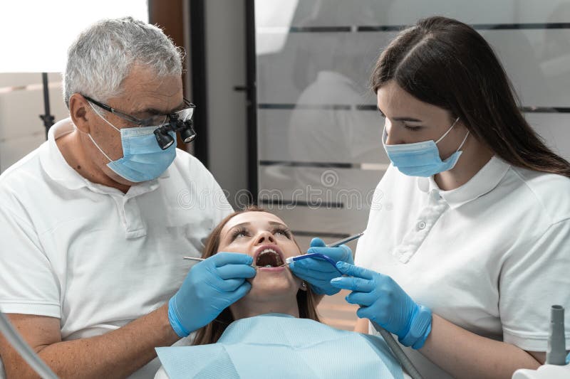 In the process of treating the patient& x27;s teeth, the dentist demonstrates high accuracy and attentiveness. She monitors every stage, guaranteeing high-quality restoration of the health and beauty of a smile. High quality photo. In the process of treating the patient& x27;s teeth, the dentist demonstrates high accuracy and attentiveness. She monitors every stage, guaranteeing high-quality restoration of the health and beauty of a smile. High quality photo