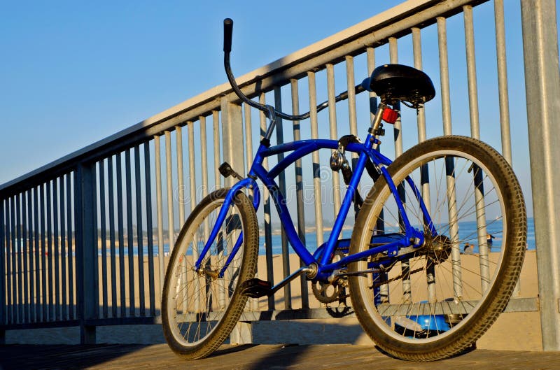 Beach Cruiser style bike parked along a railing at the beach near the Boardwalk at Santa Cruz, California. Boardwalk rail stock images, royalty-free photos and pictures