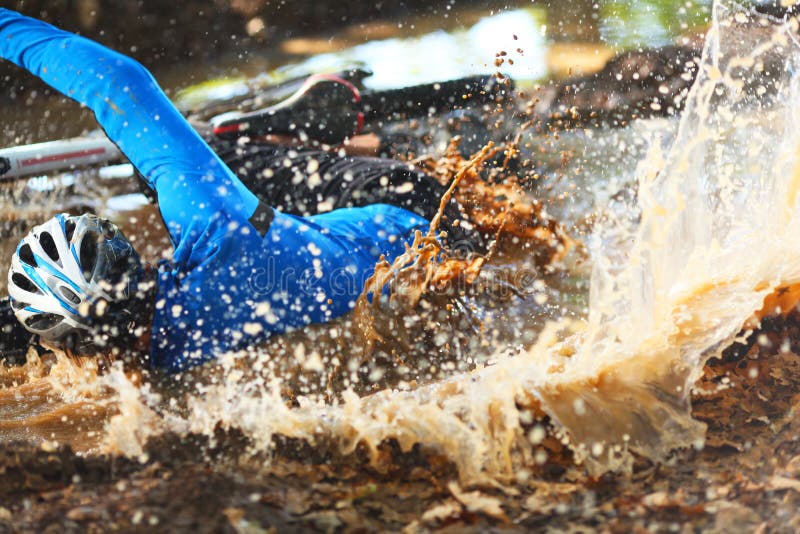 Biker falling in a pool of dirty water royalty free stock photos Biker falling in a pool of dirty water royalty free stock photos