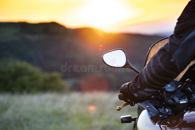 Biker hand rests on the steering wheel motorcycle