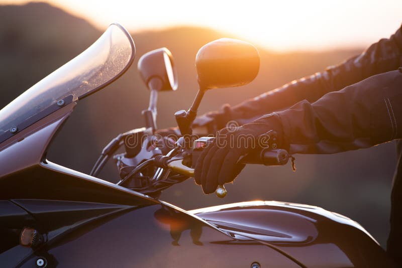 Biker hand rests on the steering wheel motorcycle