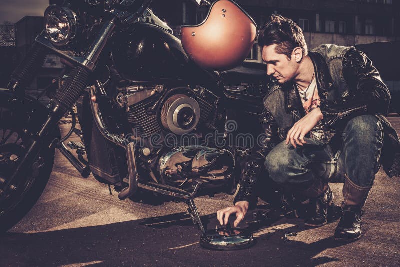 Biker and his bobber style motorcycle