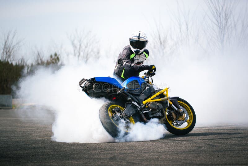 Free Photo  Moto rider making a stunt on his motorbike biker