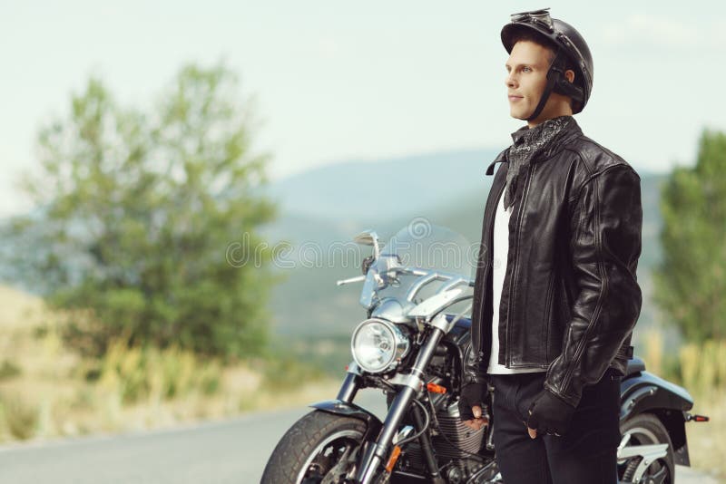 Biker Standing in Front of a Motorcycle Stock Photo Image of