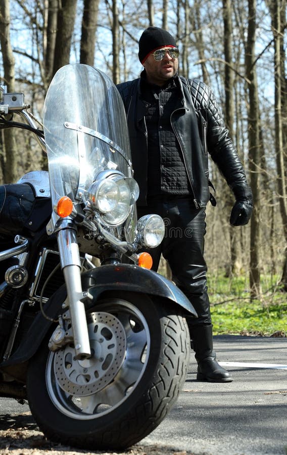 Biker stands near his bike