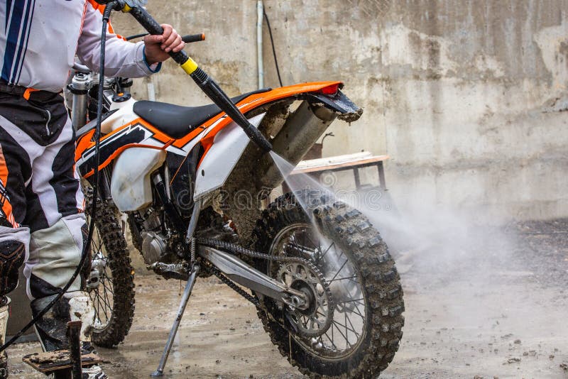 Biker washes a motorcycle stock photo. Image of road 117347094