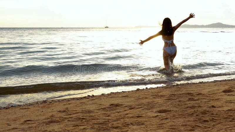 Bikini sexy asian young woman her running freedom at seaside beach tropical resting and relaxation travel lifestyle, Happy female. Freedom on summer vacation royalty free stock image