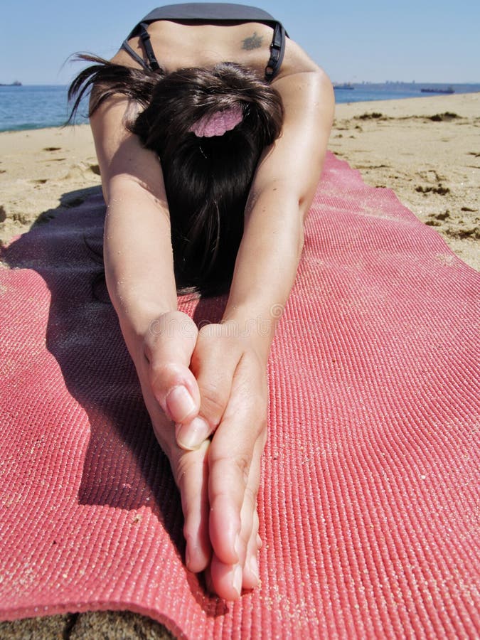 Bikram yoga ardha kurmasana pose at beach stock photography Bikram yoga ardha kurmasana pose at beach stock photography