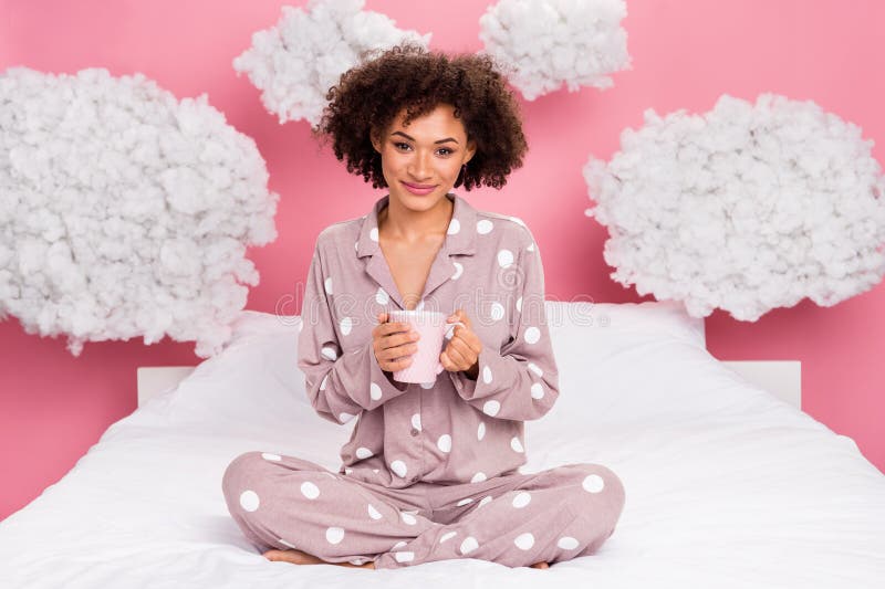 Photo of adorable pretty lady wear pajama enjoying morning coffee fluffy clouds isolated pink color background. Photo of adorable pretty lady wear pajama enjoying morning coffee fluffy clouds isolated pink color background.