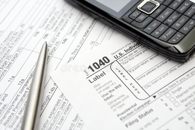 Taxes return forms, mobile phone and silver pen. Taxes return forms, mobile phone and silver pen.