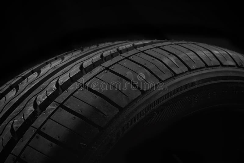 New car tire on black background. New car tire on black background