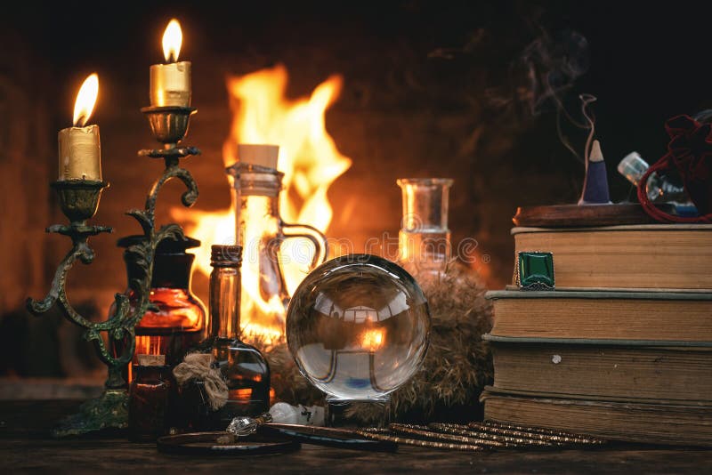 Crystal ball, magic book, magic potion and other wizard accessories on a table on a burning fire background, spell, reading, future, divination, flame, bonfire, candle, fortune, seer, clairvoyant, teller, forerunner, psychic, magician, medium, augury, sortilege, oracle, charm, destiny, enchantment, forecast, mystic, paranormal, ritual, prediction, prophecy, prophet, soothsayer, witch, witchcraft, belief, faith, enchantress, esoteric, telling, literature, equipment. Crystal ball, magic book, magic potion and other wizard accessories on a table on a burning fire background, spell, reading, future, divination, flame, bonfire, candle, fortune, seer, clairvoyant, teller, forerunner, psychic, magician, medium, augury, sortilege, oracle, charm, destiny, enchantment, forecast, mystic, paranormal, ritual, prediction, prophecy, prophet, soothsayer, witch, witchcraft, belief, faith, enchantress, esoteric, telling, literature, equipment