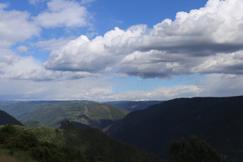 Billowy Clouds with Silhouette Mountains. Stock Photo - Image of ...