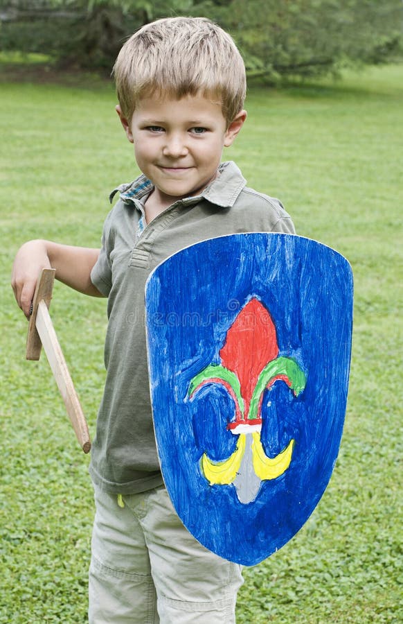 Young boy holding a sword and shield