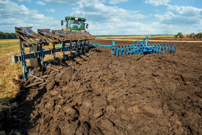 Bilogirya, Khmelnytskyi region, UKRAINE - August 19, 2021: farm tractor pulls plow, preparing the field for sowing