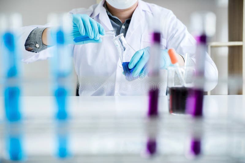 Biochemistry laboratory research, Scientist or medical in lab coat holding test tube with reagent with drop of color liquid over stock photos Biochemistry laboratory research, Scientist or medical in lab coat holding test tube with reagent with drop of color liquid over stock photos