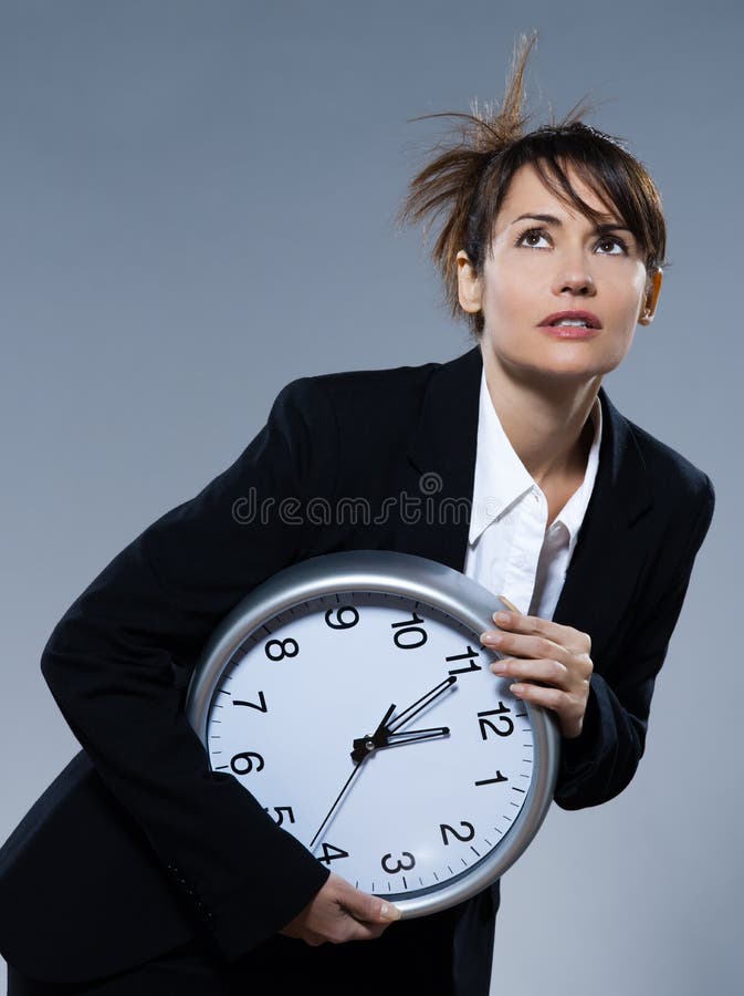 Beautiful woman on isolated backgound holding a clock. Biological clock stock images, royalty-free photos and pictures