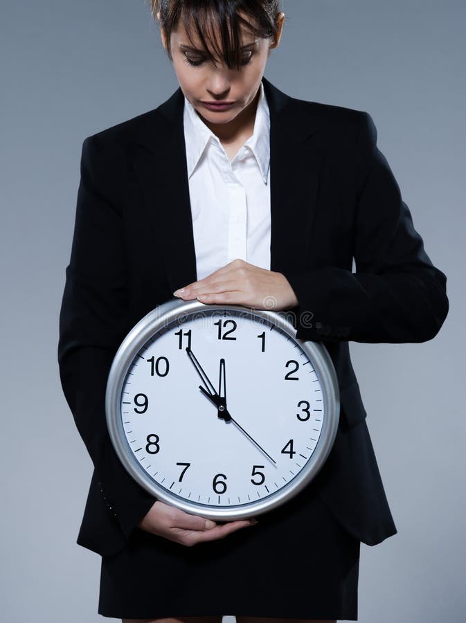 Beautiful woman on isolated backgound holding a clock. Biological clock stock images, royalty-free photos and pictures