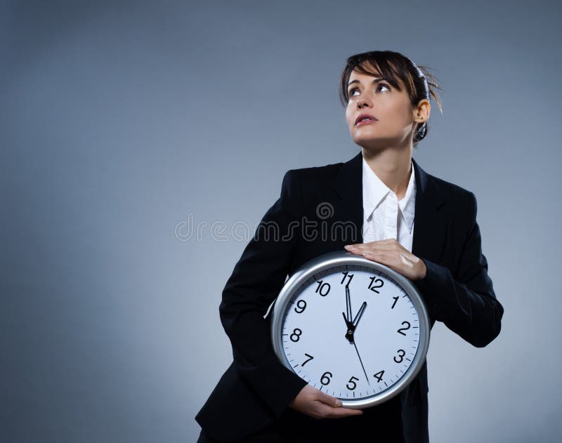 Beautiful woman on isolated backgound holding a clock. Biological clock stock images, royalty-free photos and pictures