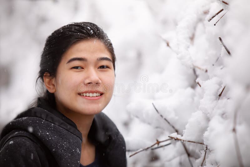 Biracial Teen Girl Outdoor in Winter Enjoying Snowfall Stock Photo ...